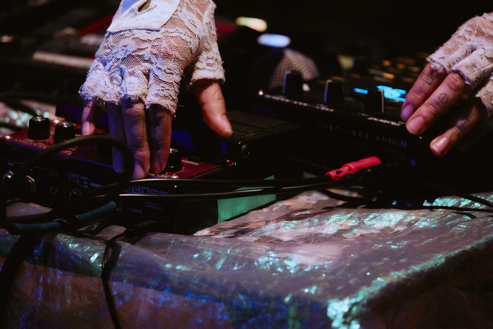 An artist working with electronic sound and production equipment.